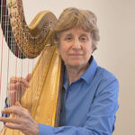Photo of JoAnn Turovsky playing the harp.