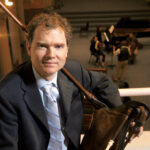 Adam Gilbert poses with an early music instrument.