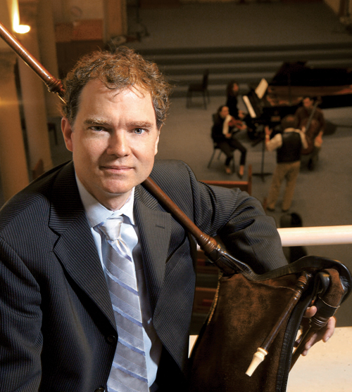 Adam Gilbert poses with an early music instrument.