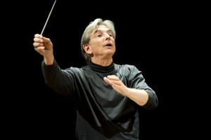 Michael Tilson Thomas with arms raised, conducting