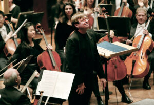 Stephen Hartke bowing with New York Philharmonic, after the world premiere of Hartke’s Symphony No. 3 in September 2003. (Photo/Chris Lee)