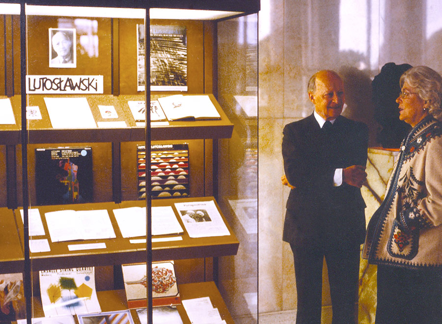 Wanda Wilk and Witold Lutoslawki chat beside a display case of artifacts highlighting the great conductor’s career.