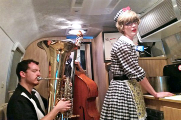 Thornton student Brandon Davis (tuba) in his Airstream trailer scene with alumna Victoria Fox, performing music by Veronika Krausas. (Photo/Jim Farber)