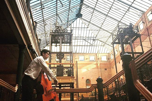 Thornton jazz alumnus Patrick Taylor takes his spot at the top of the Bradbury Building atrium. (Instagrammer @srhwnt)