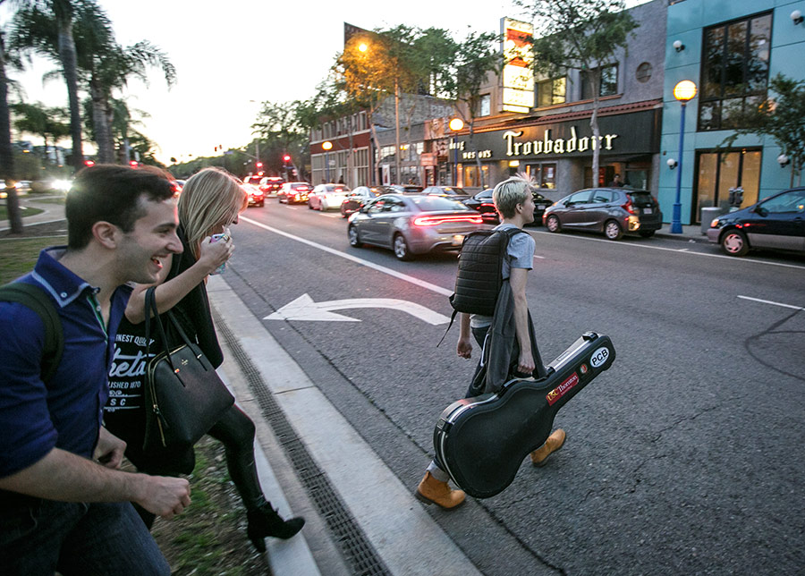 Chase Kroesche leads Morgan St. Jean, center, and Michael Arrom across Santa Monica Boulevard en route to the senior showcase at the legendary Troubadour on March 6. (USC Photo/David Sprague)