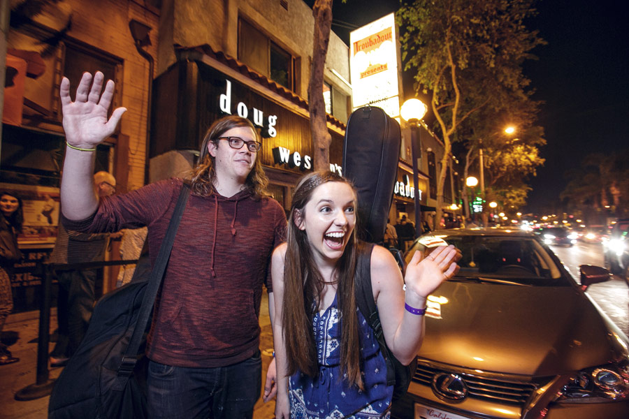 Seniors Skyler Garn and Katie Stump recognize friends arriving on Santa Monica Boulevard before the showcase at the Troubadour. (USC Photo/David Sprague)