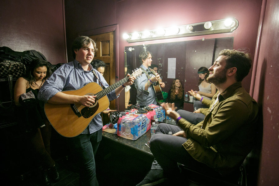 Guitarist and songwriter Alex Rosenbloom, left, and bass player Mackin Carroll, right, join other performers in the Troubadour’s dressing room. (USC Photo/David Sprague)