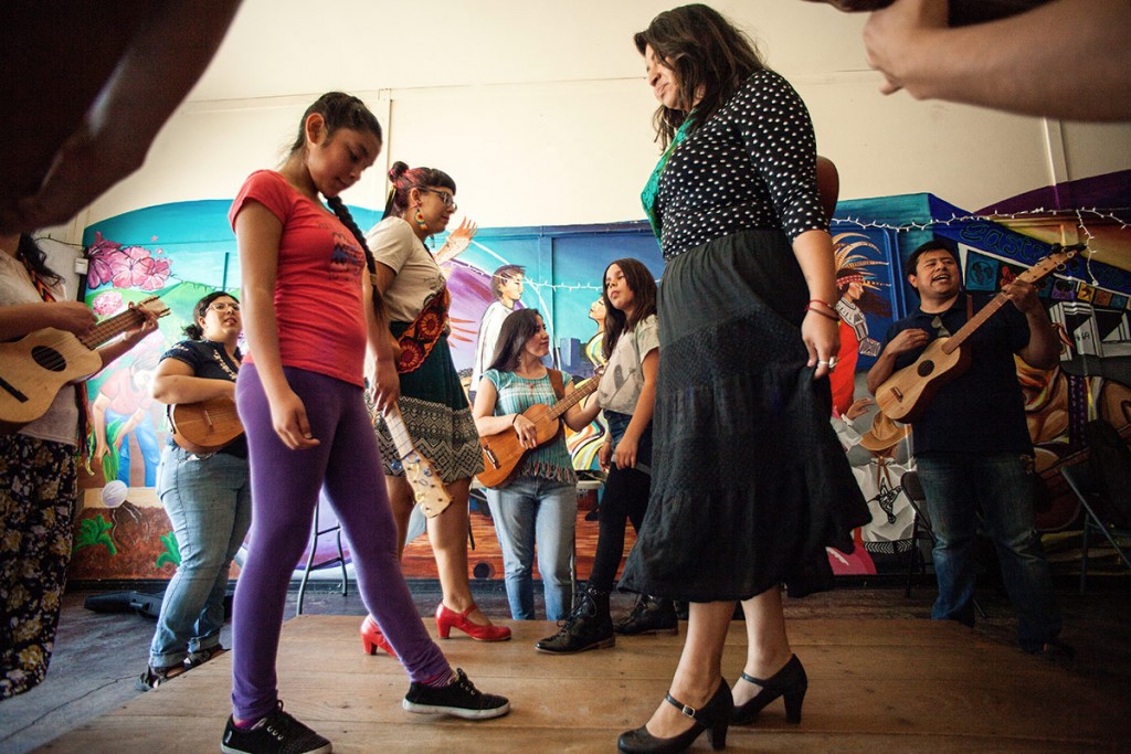 Flores leads the group in a lively zapateado (dance). Alejandra Ocasio and Laura Zavala, wearing zapateado shoes, dance with sisters Anxelli and Jah Bear. (Photo by Michael Becerra/Elefante Collective)