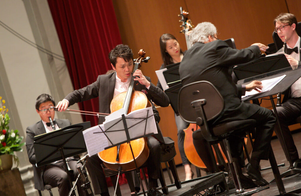 Cellist Li-Wei Qin performed Friedrich Gulda’s Concerto for Cello and Wind Orchestra with the USC Thornton Wind Ensemble, under conductor Uriel Segal at USC’s Bovard Auditorium on May 19. (Photo by Dario Griffin/USC)