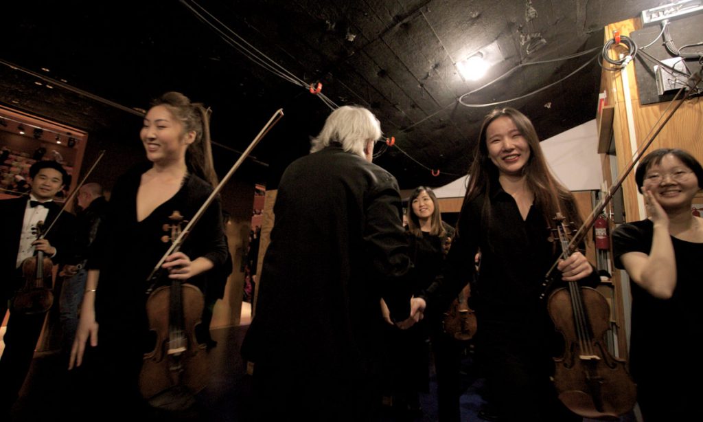 After the concert, Carl St.Clair congratulates the performers backstage.