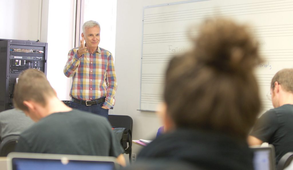 Professor Foster teaches a class of bright minds. 