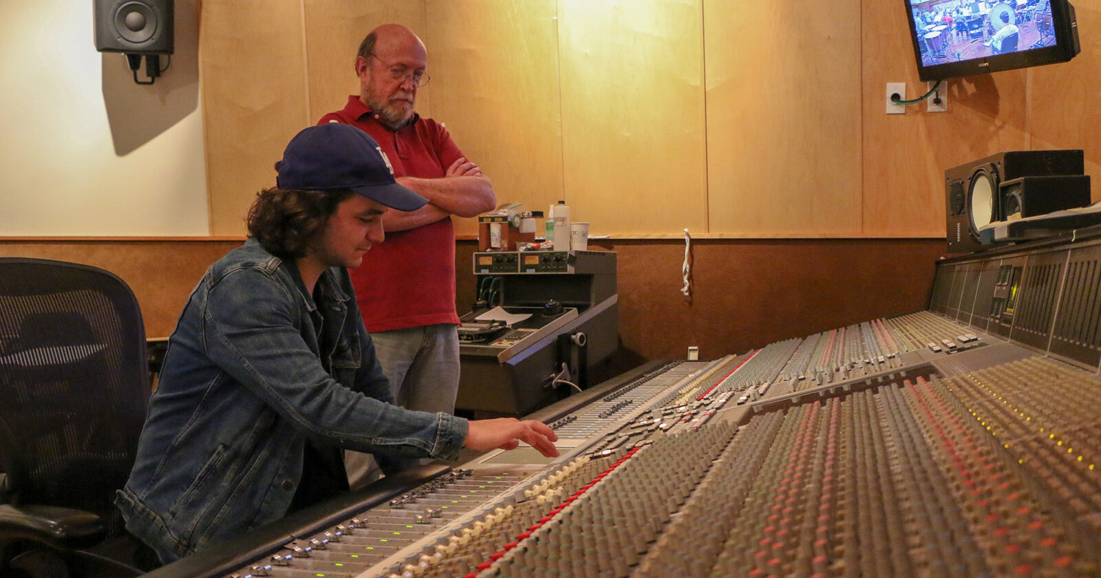 Joey Messina-Doerning (left) recording the USC Thornton Symphony while Richard McIlvery advises. 