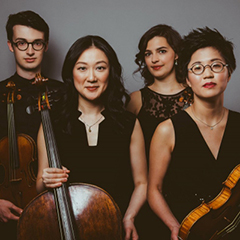 Photo of four musicians holding string instruments