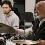 Photo of Peter Erskine with student at drums