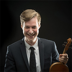 Photo of Jason Issokson holding violin