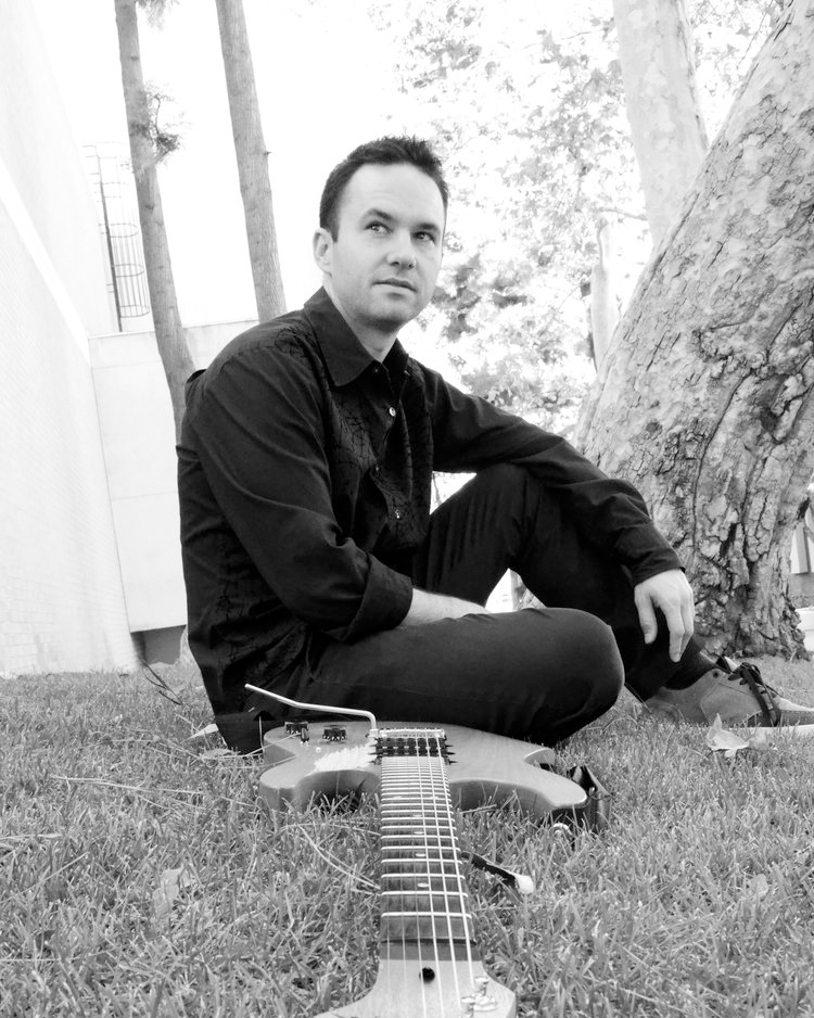 Photo of Dylan Caligiuri with guitar