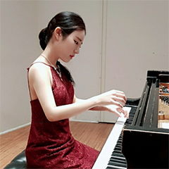 Photo of Doyoung Park seated at piano in formal attire