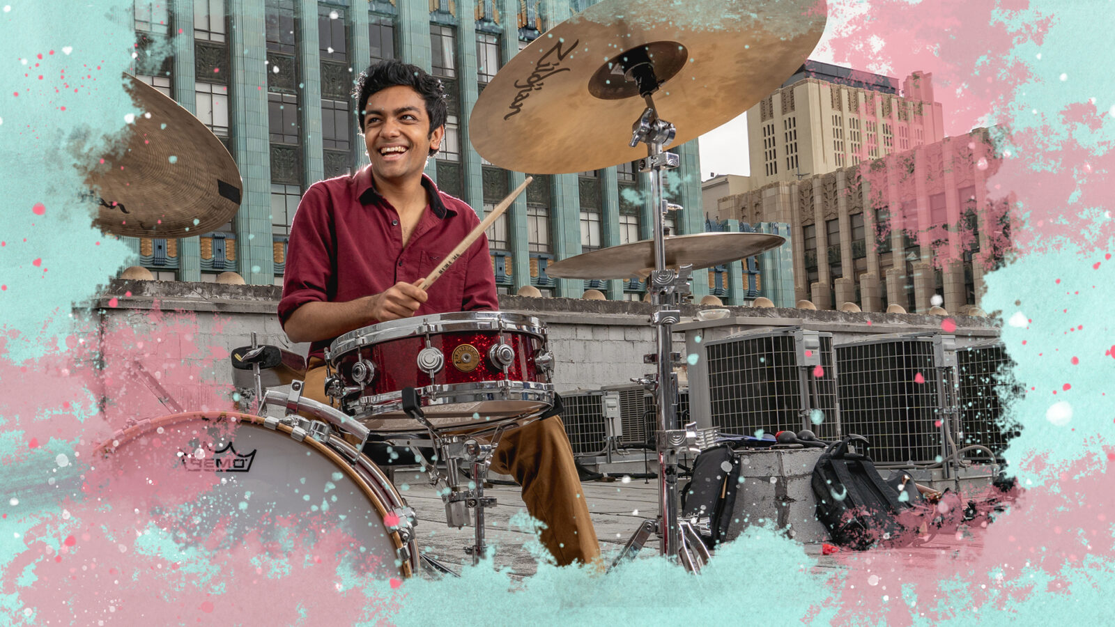 Image of drummer on downtown rooftop, surrounded by an illustration of splashy colors 