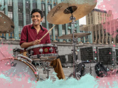 Image of drummer on downtown rooftop, surrounded by an illustration of splashy colors