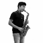 black and white picture of Simon Hwang playing saxophone