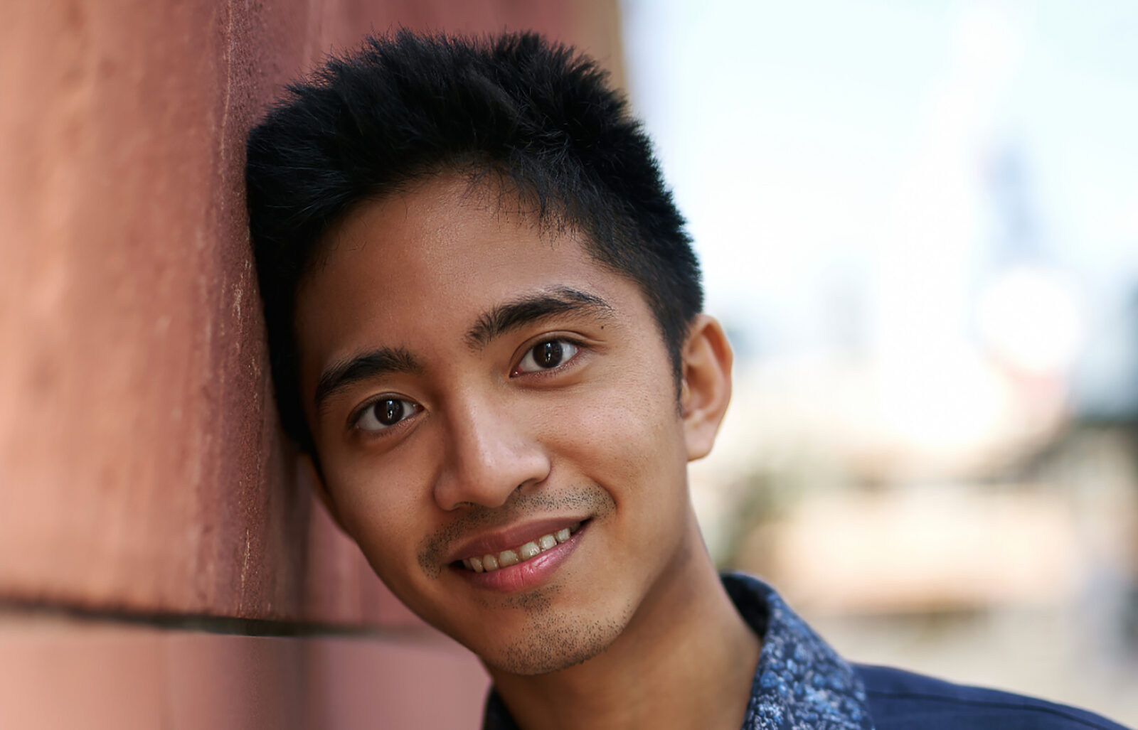 Portrait of Jay leaning against a wall 