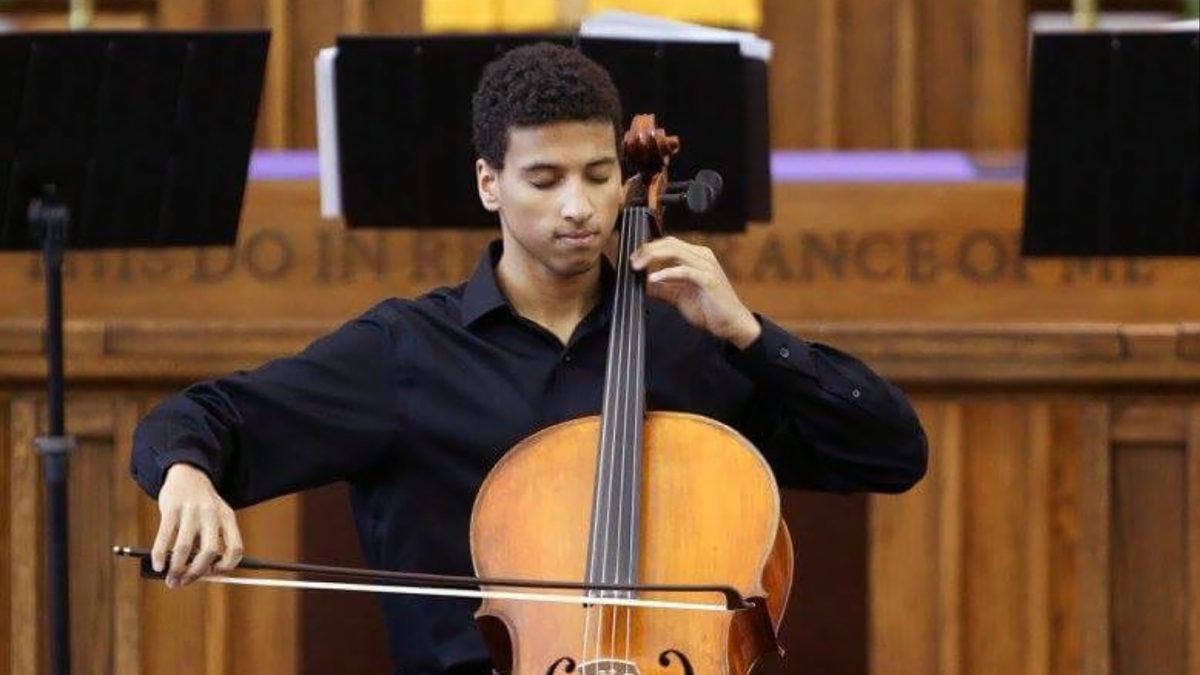 Myles Yeazell dressed in concert black playing the cello 