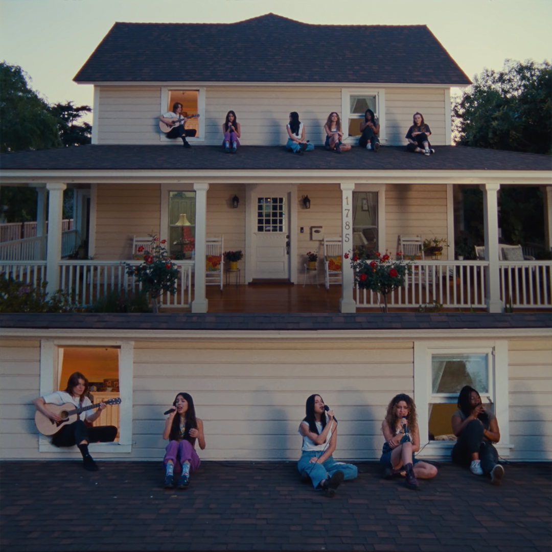 Musicians perform on a rooftop at sunset