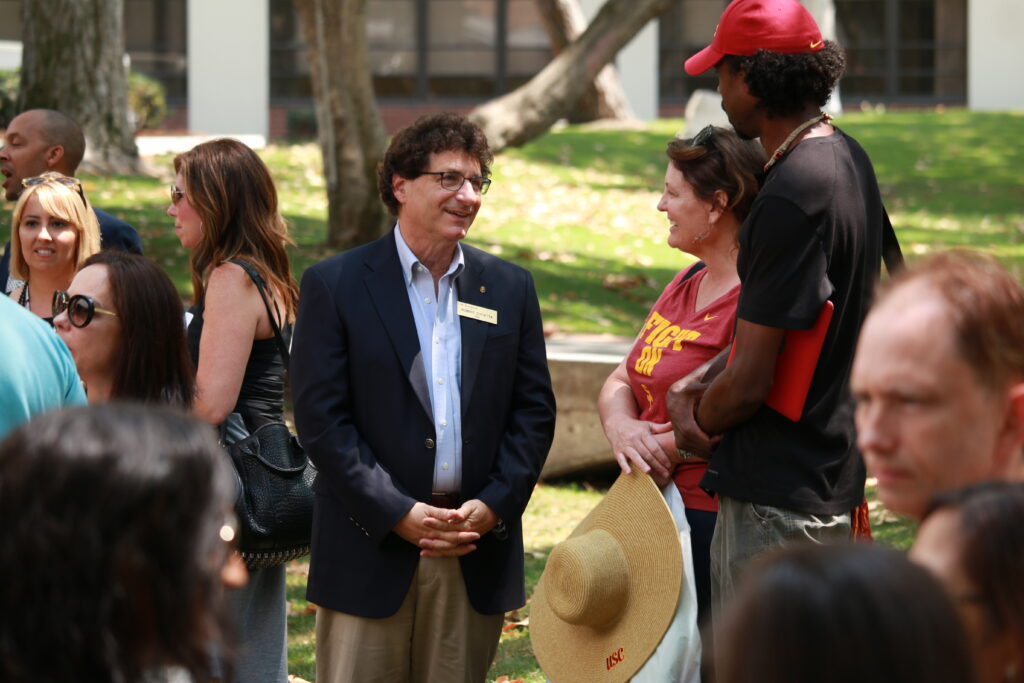 Dean Cutietta speaks outdoors with parents at an open house event for the USC Glorya Kaufman School of Dance.