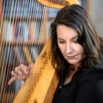 Photo of Maxine Eilander playing harp