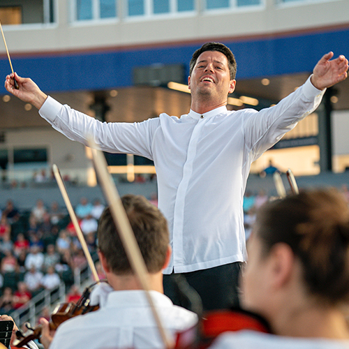 USC Thornton faculty member Troy Quinn conducts an outdoor symphony performance