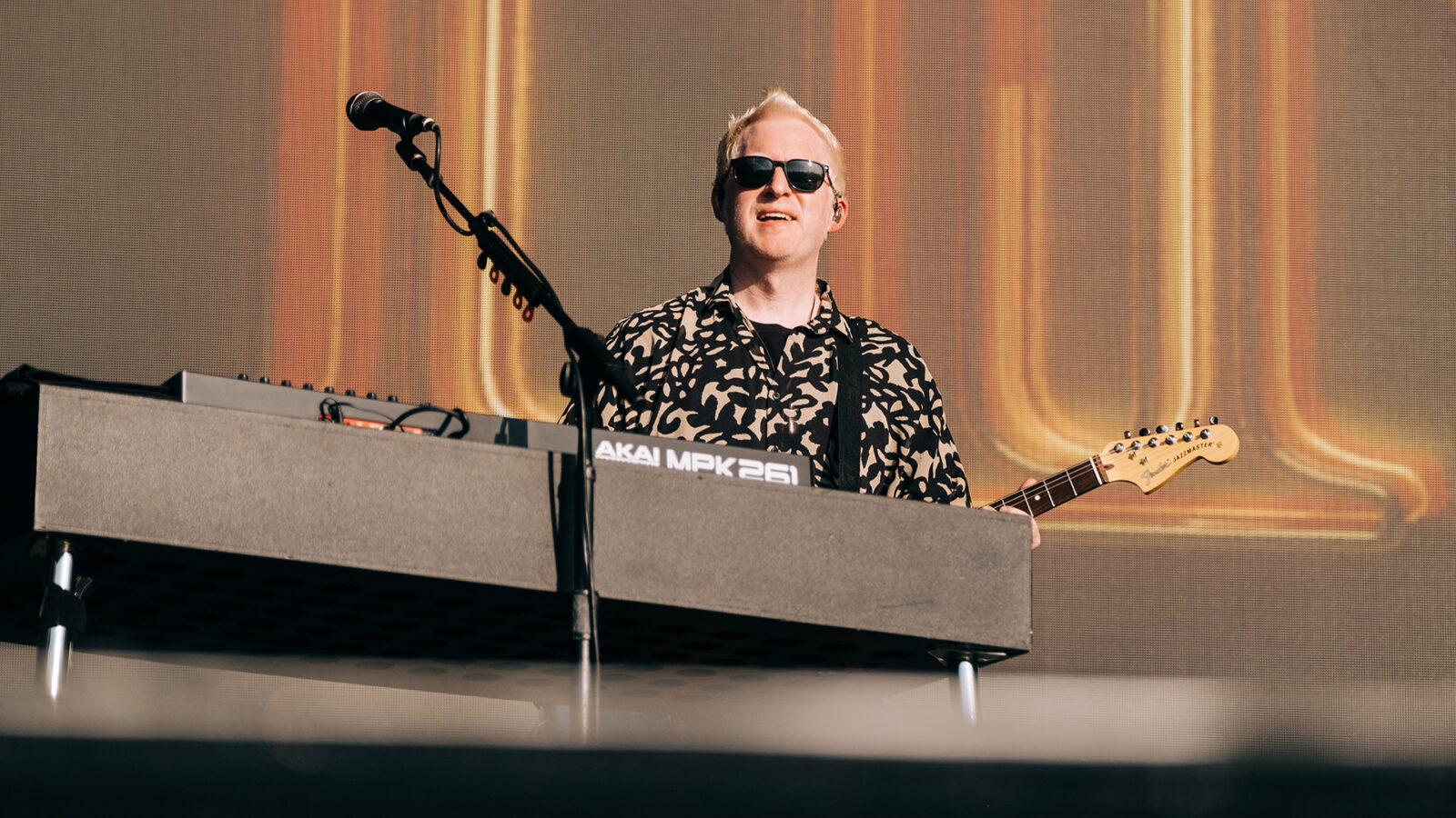 Photo of Aron Forbes performing on stage with electric guitar 