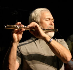 Photo of Jim Walker performing flute on stage.