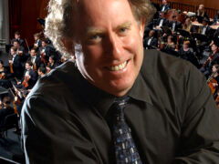 Photo of Jeffrey Kahane superimposed on image of the USC Thornton symphony