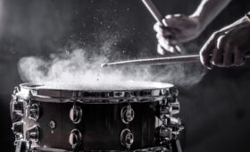 Snare drum played in close up with dramatic lighting