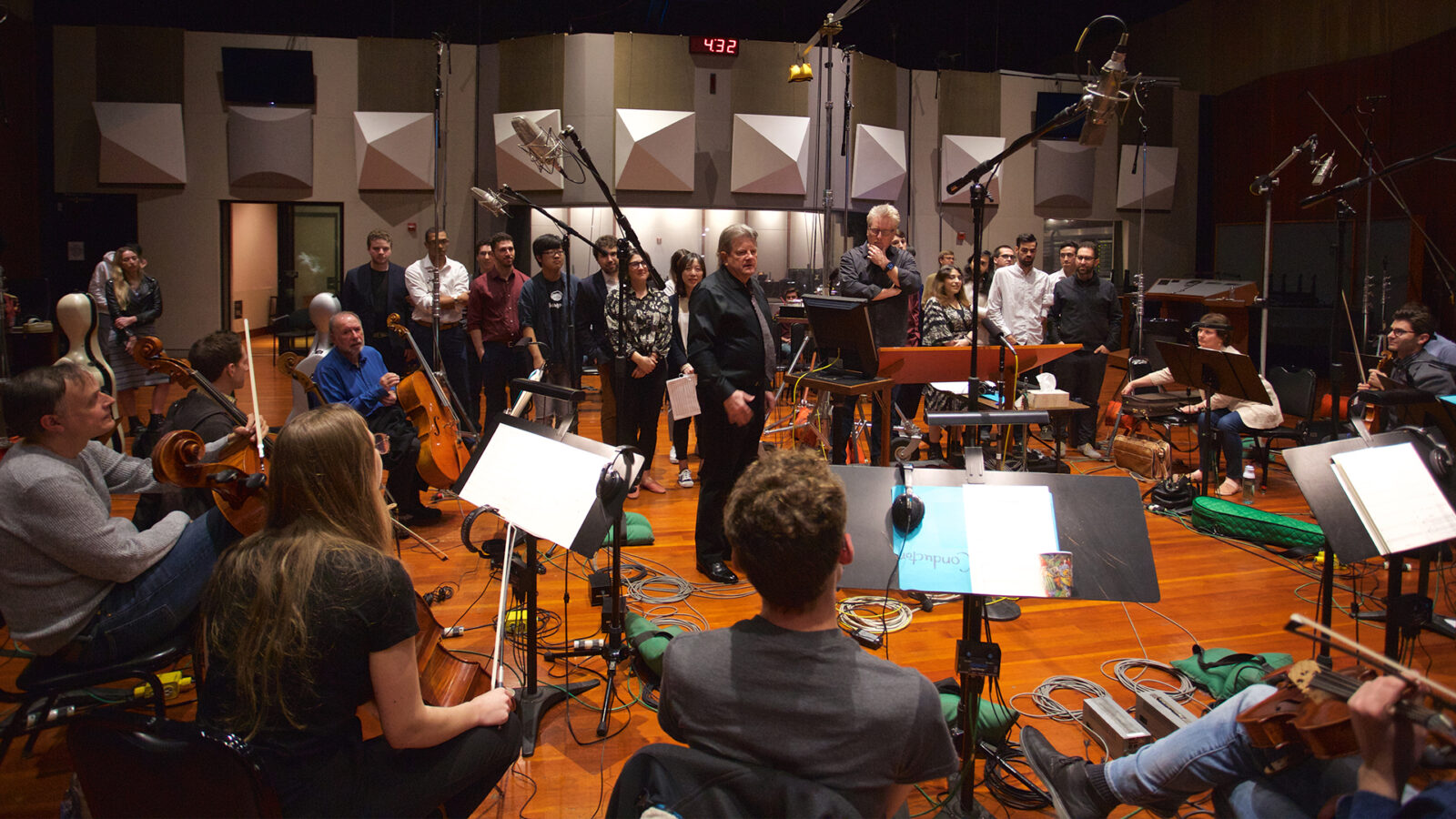 Photo of Daniel Carlin with students on the Warner Bros. Eastwood Scoring Stage 