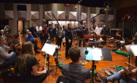 Photo of Daniel Carlin with students on the Warner Bros. Eastwood Scoring Stage