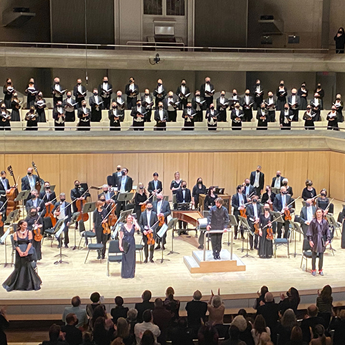 Choir singing in a concert hall with chamber orchestra