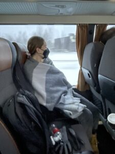 Student bundled up on an early morning bus ride