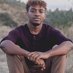 Photo of Justus Ross seated outdoors