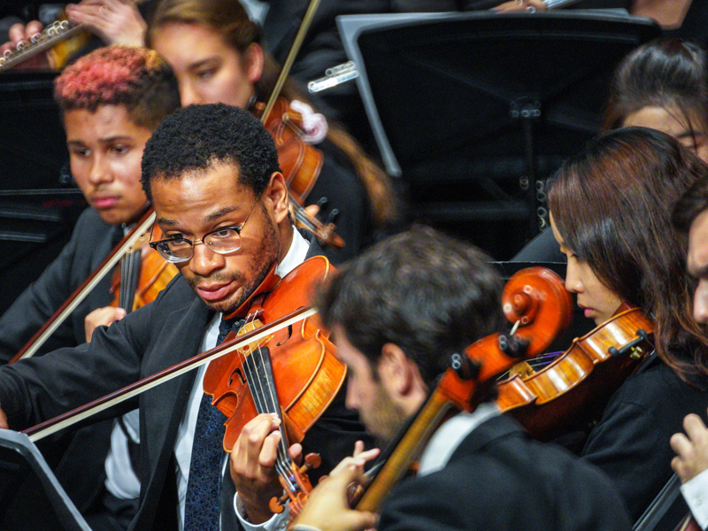 Six USC Thornton students are in this close-up view of the Thornton Symphony strings section. 
