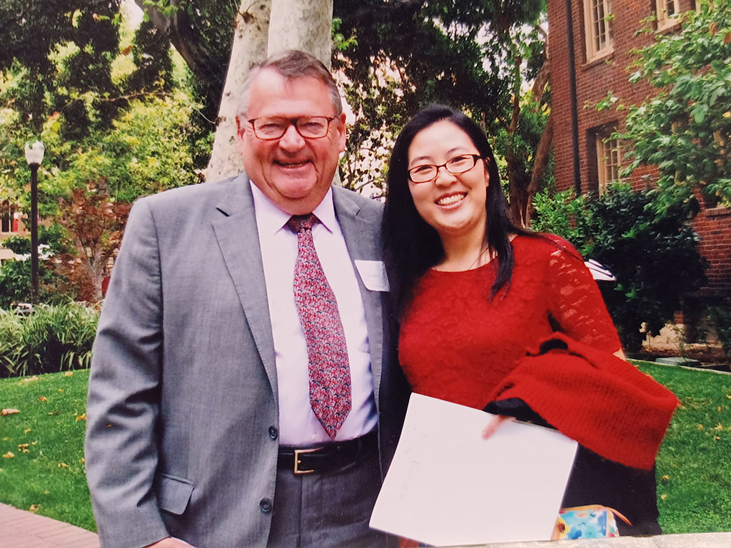 Photo of Peter Webster and Tina Huynh smiling outside 