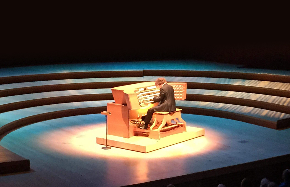 Photo of Thomas Mellon playing pipe organ on stage at Walt Disney Concert Hall.
