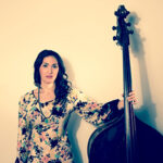 Photo of Katie Thiroux holding an upright bass.