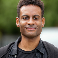 Photo of a screen scoring student smiling outdoors.