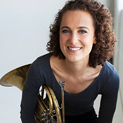 Photo of Anni Hochhalter holding at French horn.