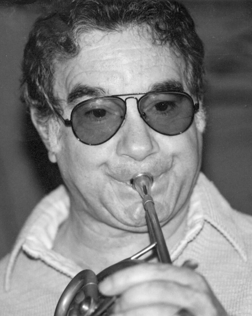 Photo of Vincent DeRosa performing the French horn in the 1970s.
