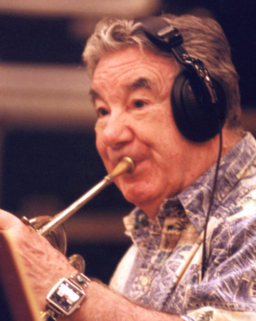 Photo of Vincent DeRosa performing the French horn in the 1990s.