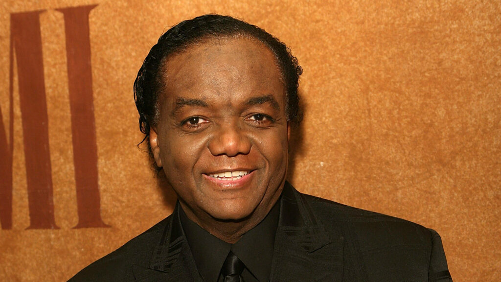 Photo of Lamont Dozier attending an awards show in dress attire.