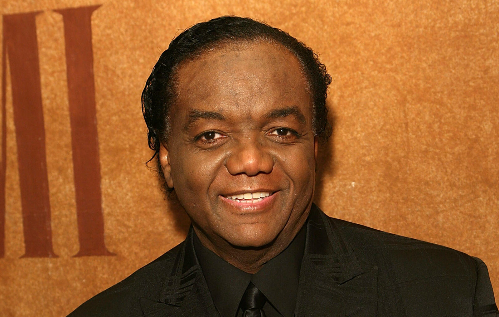 Photo of Lamont Dozier attending an event in concert attire. 