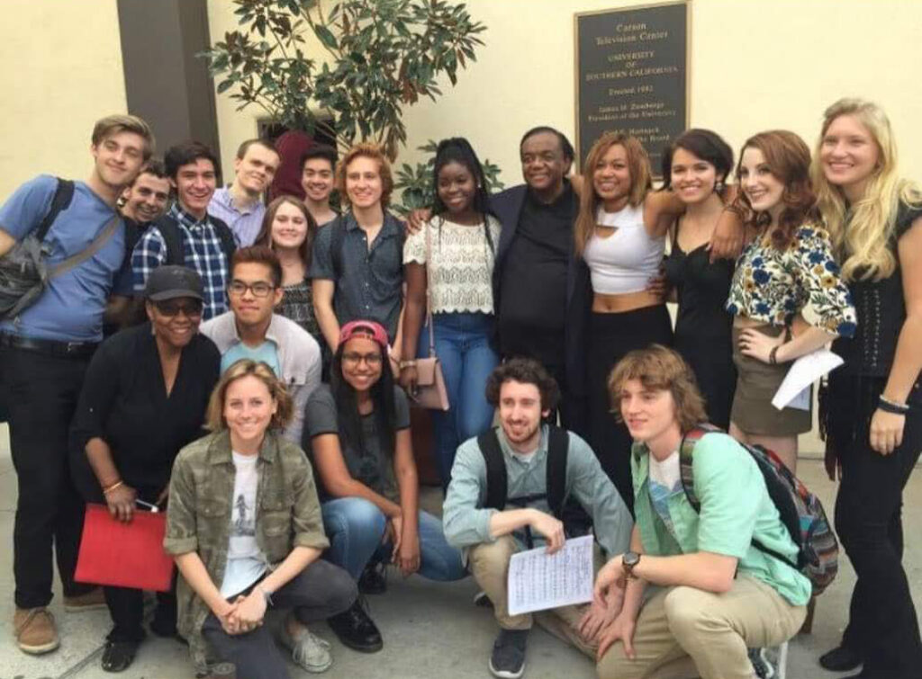 Photo of USC Thornton music students gathering for a group photo outside a concert hall on the campus of the University of Southern California.